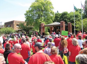 Red-shirted Washington Education Association teachers from Sequim and Port Angeles gather at Veterans Park in Port Angeles midday Monday to hear speakers and music by a disc jockey