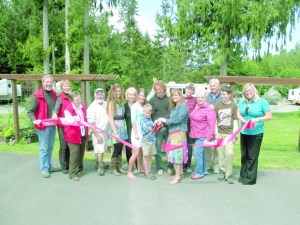 From left at a ribbon-cutting to recognize Elwha Dam RV Parks new ownership are Port Angeles Ambassadors Howard Fisher