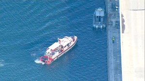 A boat from East Kitsap Fire-Rescue stands alongside the Hood Canal Bridge during search operations.  KOMO News ()
