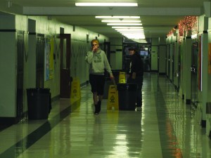 Students walk around trash cans placed in the hallways of Port Angeles High School last December to catch rain water leaking into the building though the failing roof.  Arwyn Rice/Peninsula Daily News ()