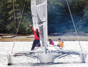 Matt Steverson raises his arm as the Team Elsie Piddock trimaran is first to cross the finish line in the inaugural Race to Alaska that began in Port Townsend. Fellow crew are Graeme Esarey