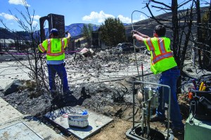 A utility crew sets out to replace the cable that was destroyed inside the Broadview neighborhood by this weekends fire in Wenatchee on Tuesday. The Sleepy Hollow fire in Wenatchee claimed some two dozen homes and several commercial buildings downtown.  Dean Rutz/The Seattle Times via The Associated Press