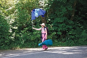 Sallie Spirit Harrison walks along U.S. Highway 101 on her way to Lake Quinault.
