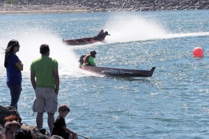 Outboard-powered dugout canoes round the south turn on the Quillayute River during Quileute Days 2015 in La Push. (Lonnie Archibald/for Peninsula Daily News)
