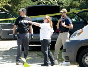 State Patrol forensic scientist Sara Trejo meets with Jefferson County sheriffs Detectives Ryan Menday