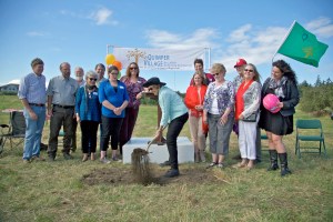 Co-founder Pat Hundhausen turns the first spade of earth at the Quimper Village building site in Port Townsend. ()
