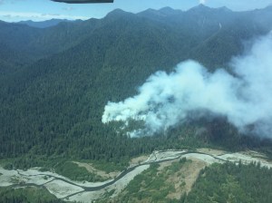 Smoke from the Paradise Fire billows from the forest near the Queets River in Olympic National Park on Monday. The blaze grew by 504 acres over the weekend.  Olympic National Park