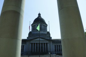 The state Capitol is seen through the columns of the state Supreme Court on Thursday in Olympia. The court has issued sanctions of $100