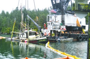 Workers with Global Diving & Salvage pull the 65-foot pleasure craft Avalon out of Pleasant Harbor in Brinnon after it sank in September.  State Department of Natural Resources