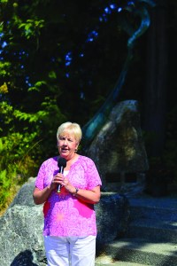 Port Angeles Fine Arts Center foundation president Phillis Olson speaks at the entrance to Websters Woods