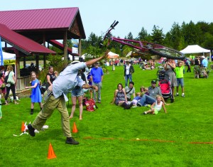 Damian Wright of Port Townsend participates in a bicycle toss at the All County Picnic on Sunday in Chimacum. Wright threw the bike more than 19 feet.  Charlie Bermant/Peninsula Daily News