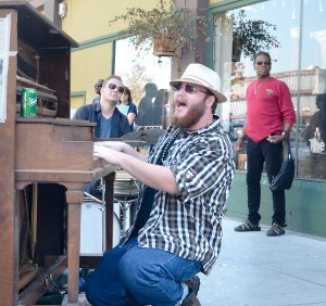 Chris Flowers pounds out a Jerry Lee Lewis tune on the Port Townsend community piano Thursday afternoon. Also pictured is drummer Aaron Fowler and passerby Lee Brown.  Charlie Bermant/Peninsula Daily News