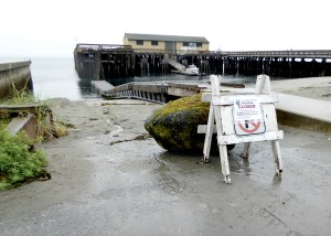 Park personnel moved a boulder in front of the Fort Worden State Park boat ramp to enforce its closure.  Charlie Bermant/Peninsula Daily News