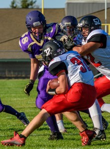 Sequim's Matthew Schock (58) tangles with Coupeville lineman Jacob Martin (52) while trying to track down running back Jacob Martin (32) earlier this season. George Leinonen/for Peninsula Daily News