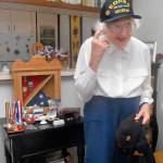 Mary Reid of Port Angeles, 90, a U.S. Army veteran of the Korean War, shows of one of her many caps that distinguish her service to her country. (Keith Thorpe/Peninsula Daily News)