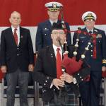 Bagpiper Rick McKenzie, a retiree from the U.S. Coast Guard, plays Amazing Grace to help close out Saturdays Veterans Day ceremony. On the podium behind were, from left, retired U.S. Marine Corp Col. Thomas Johnson, Capt. Mark Hiigel, commanding officer of U.S. Coast Guard Air Station/Sector Field Office Port Angeles, and Coast Guard District 13 Chaplain Cmdr. William Stuart. (Keith Thorpe/Peninsula Daily News)
