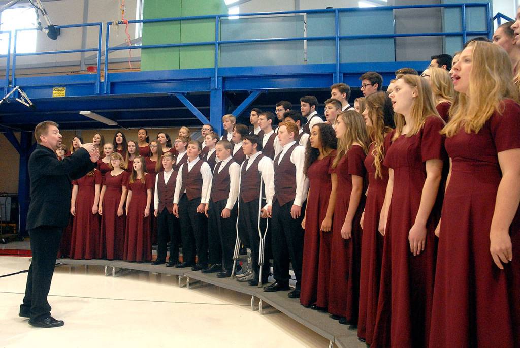 The Select Choir from Sequim High School, directed by John Lorentzen, sings The Star-Spangled Banner in the hanger at U.S. Coast Guard Air Station/Sector Field Office on Veterans Day. (Keith Thorpe/Peninsula Daily News)
