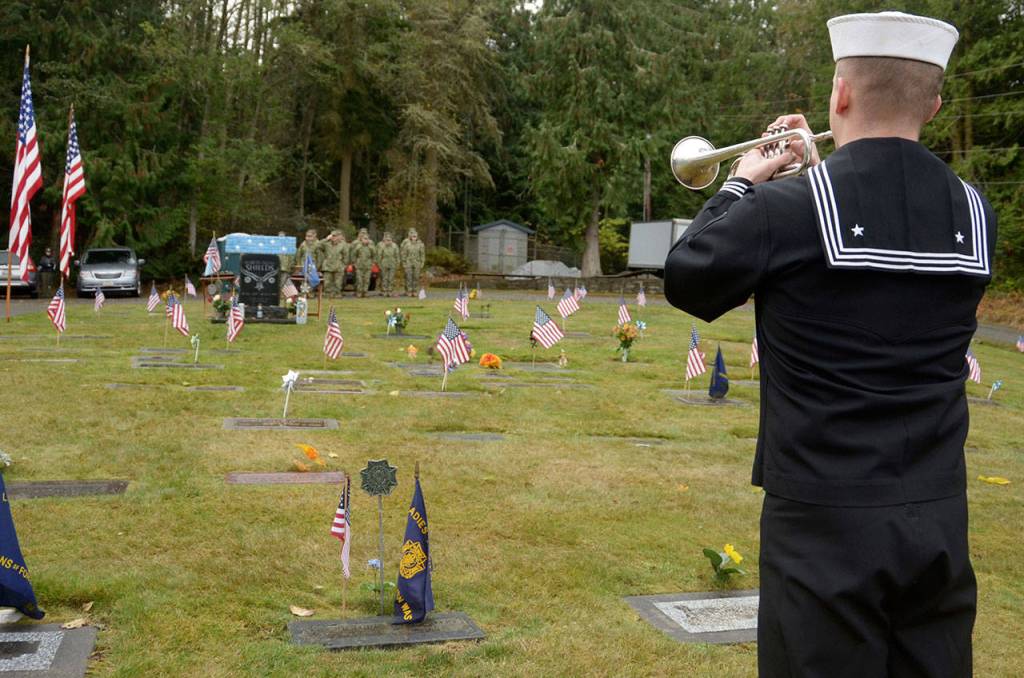 Taps is played at the end of a Veterans Day event honoring Seabee Marvin G. Shields of Port Townsend on Saturday at the Gardiner cemetery. (Cydney McFarland/Peninsula Daily News)