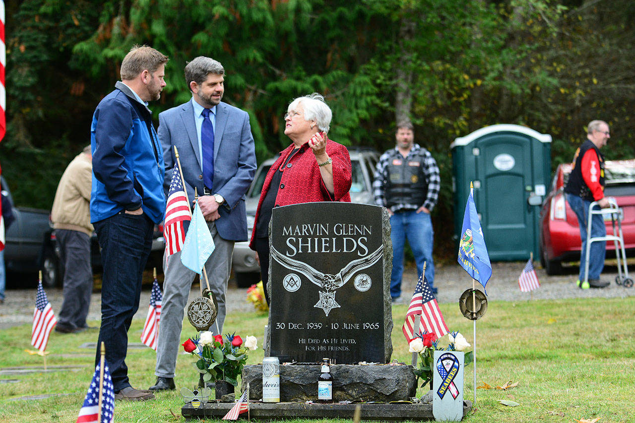 State Rep. Mike Chapman, D-Port Angeles, left, and Clallam County Commissioner Mark Ozias talk with Joan Shields-Bennett before a Sojourner memorial service honoring her late husband, Marvin G. Shields, on Saturday. (Jesse Major/Peninsula Daily News)
