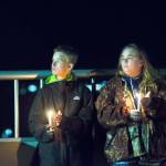 Nikki Drake and her son, Logan Leffel, attend a vigil on the Eighth Street bridge over Valley Street on Monday after Ashley Wishart, 15, jumped to her death earlier in the day. (Jesse Major/Peninsula Daily News)