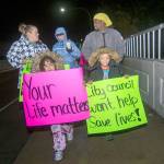 Protesters took to the Eighth Street bridges Monday night, calling on the city of Port Angeles to add taller fences to the spans. (Jesse Major/Peninsula Daily News)