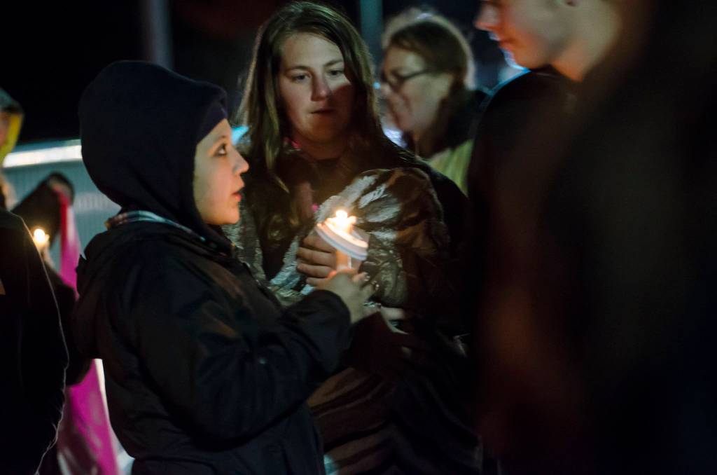 Sammi Bates, 16, holds a candle honoring the life of her friend, Ashley Wishart, 15. who jumped to her death from the Eighth Street bridge over Valley Street on Monday. (Jesse Major/Peninsula Daily News)