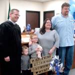 Clallam County Superior Court Commissioner W. Brent Basden, Drew Johnson, Wyatt Johnson, Tina Johnson and Greg Johnson, from left, pose for a photograph commemorating Wyatts Forever Family Day. (Sarah Sharp/Peninsula Daily News)