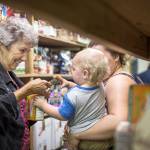 Eloise Langenbach, the coordinator for the Brinnon Food Bank, helps a client in this still shot from the WhyHunger video.