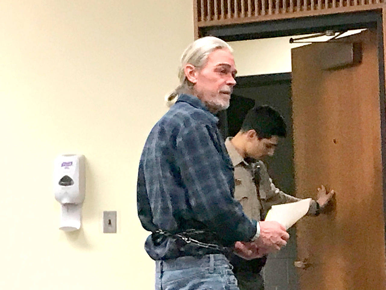 Gary Blanton headed back to jail Monday after a first appearance in Clallam County Superior Court for allegedly shooting at a neighbors house. (Paul Gottlieb/Peninsula Daily News)