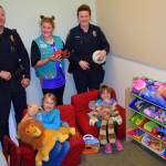 Heidi Krzyworz                                Sequim Police Officers Sgt. Mike Hill and Stephanie Benes visit with Sequim Girl Scouts, from front left, Johanna Beckerley-Kohl, Caydence Barnett and Paige Krzyworz as they refurbish the Cozy Cove, a child-friendly space in the Sequim Police Department. The girls worked 20-plus hours each on planning and implementing the project.