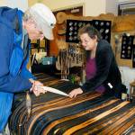 Artist Jenny Preston describes her technique for making leather belts to recent Port Townsend transplant George Stanley. Preston uses knife work, stamping and dyes on her top grain cowhide creations. (Jeannie McMacken/for Peninsula Daily News)