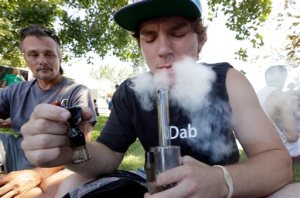 Cody Park exhales a cloud of marijuana smoke after taking a hit on a bong at the first day of Hempfest in Seattle. The Associated Press