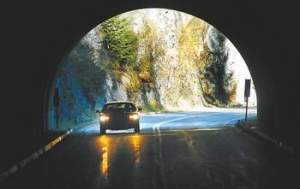 A car makes its way through the third of three tunnels on the way up Hurricane Ridge Road in Olympic National Park. Keith Thorpe/Peninsula Daily News