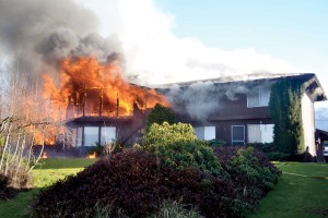 Flames engulf the living room area of this view home on East Park Avenue near Franklin School in Port Angeles today. Greg Roberts/for Peninsula Daily News