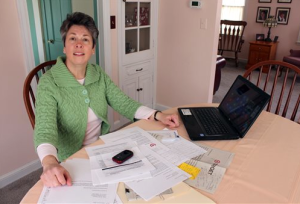 Laura Hankins sits with the paperwork  that she needed to go through to help her 19-year-old daughter with her federal returns after finding out that someone using her name had already filed for a refund. The Associated Press