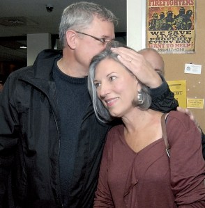 Mary Ellen Winborn gets a kiss from her husband