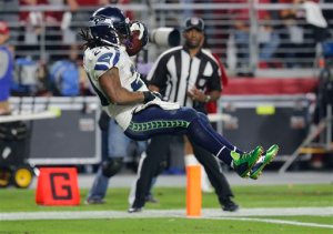 Seattle Seahawks running back Marshawn Lynch (24) leaps into the end zone for a touchdown against the Arizona Cardinals last Sunday. Where he has his right hand will cost him more than $11