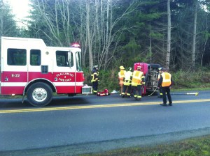 A woman is taken to Olympic Medical Center after a single-car wreck on state Highway 112 near Place Road on Friday morning. Clallam County Fire District No. 2