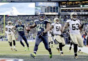 Seattle Seahawks running back Marshawn Lynch (24) arrives in the end zone with a 31-yard touchdown during the fourth quarter Saturday. — Photo by John Froschauer/The Associated Press