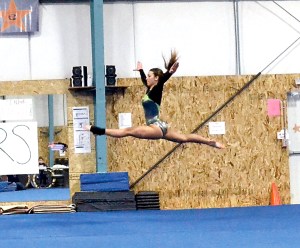 Port Angeles senior Madylan Coventon leaps during her floor routine.