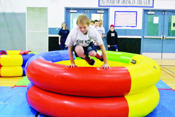 Student Dakota Schulz vaults over a fitness wheel during a Tumbl Trak event at Blue Heron Middle School in Port Townsend last week. Charlie Bermant/Peninsula Daily News