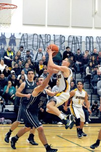 Forks freshman Parker Browning scores over Montesano's Kenny Roy (20) and Evan Bialkowsky (44). Lonnie Archibald/for Peninsula Daily News