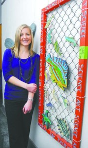 Feiro Marine Life Center board member Morgan Fox stands next to a "Fish on the Fence" display in Port Angeles. Keith Thorpe/Peninsula Daily News