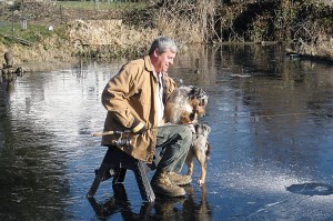 Joe Munn fishes through the ice at Lake Leland. Munn caught three trout fishing from the dock through a hole in the ice.