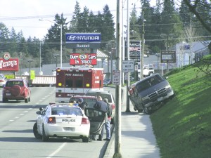 A Dodge van traveling west in the eastbound lanes came to a stop on an embankment Sunday afternoon in Port Angeles after its driver reportedly suffered a seizure. Arwyn Rice/Peninsula Daily News