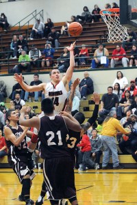 Neah Bay's Zeke Greene releases a shot amid a pack of Lummi defenders during the Tri-District playoffs at Port Angeles High School last month. Lonnie Archibald/for Peninsula Daily News