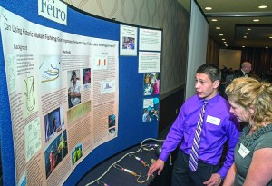Makah tribal member Alex Wise discusses his halibut hook project with Jacqueline Laverdure