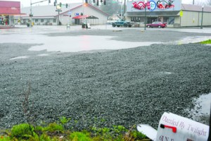 The empty lots of the International Order of Odd Fellows and Dazzled by Twilight buildings collect rain earlier this week. Lonnie Archibald/Peninsula Daily News