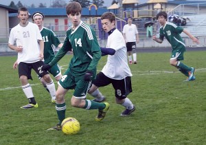 Port Angeles' Scott Methner and Sequim's Eli Berg battle for control of the ball at Sequim High School. Also in on the play is Cameron Chase (21) of Sequim and Vincent Ioffrida (11) and Wei-Yen Fu (10) of Port Angeles. Dave Logan/for Peninsula Daily News