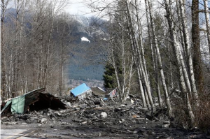 A demolished house sits in the mud on State Highway 530 on Sunday